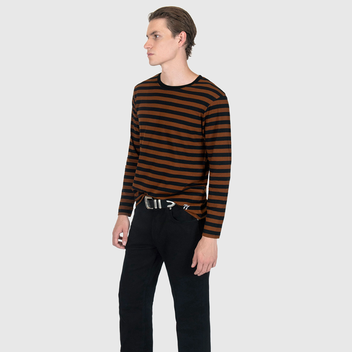 The Fitz 77 is a black and brown striped, long sleeve t-shirt. This soft cotton-poly blend allows the fabric to drape comfortably on your torso. It features a subtle 77 embroidered on the lower corner. This is our Bucktown fit.