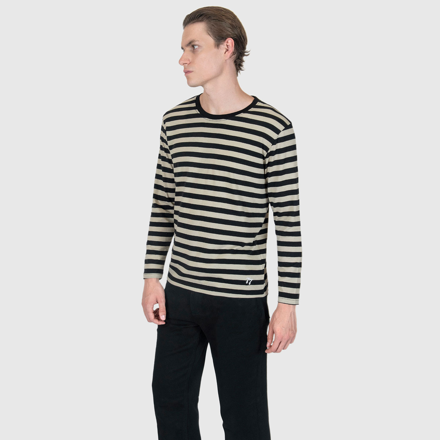 The Fitz 77 is a black and cream striped, long sleeve t-shirt. This soft cotton-poly blend allows the fabric to drape comfortably on your torso. It features a subtle 77 embroidered on the lower corner. This is our Bucktown fit.