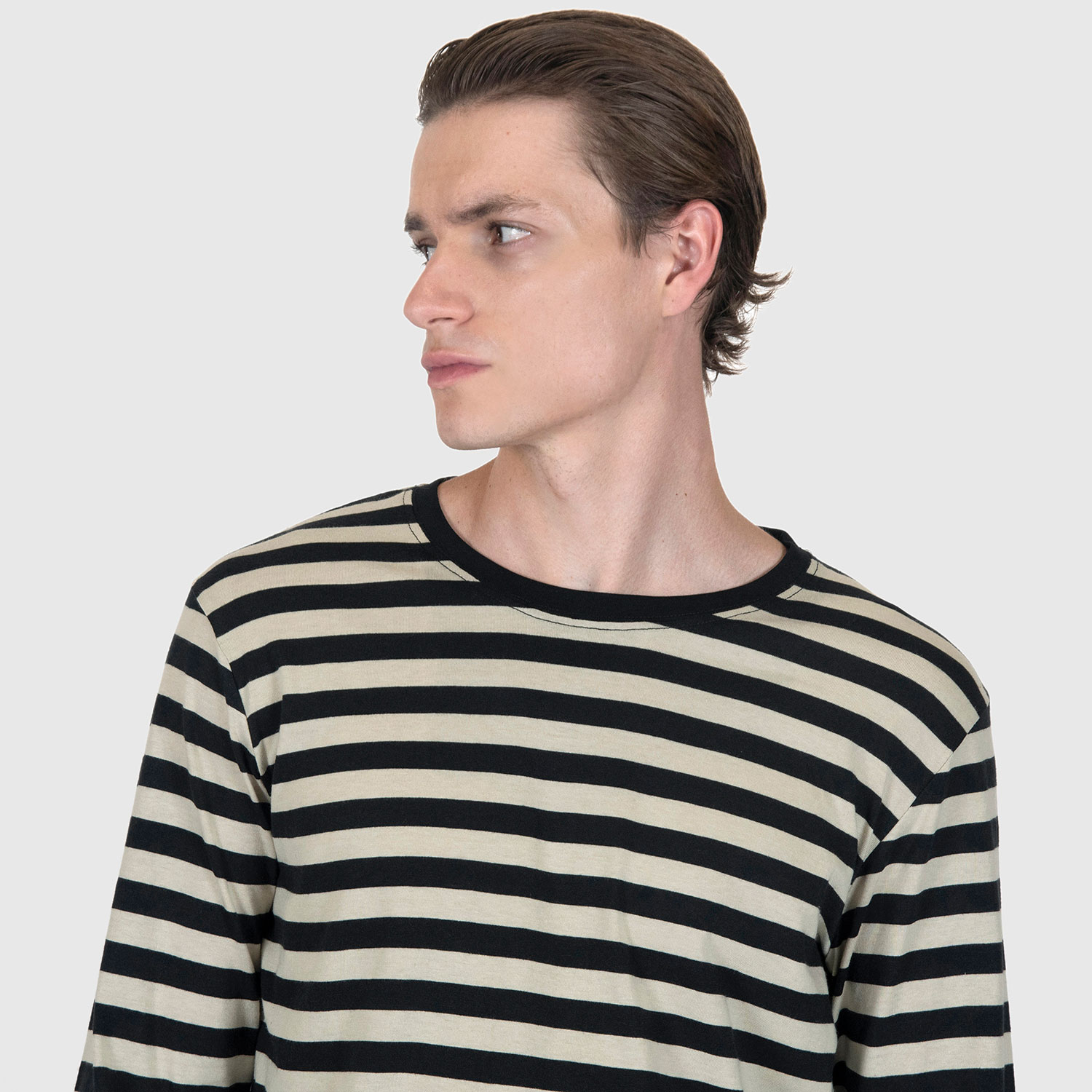 The Fitz 77 is a black and cream striped, long sleeve t-shirt. This soft cotton-poly blend allows the fabric to drape comfortably on your torso. It features a subtle 77 embroidered on the lower corner. This is our Bucktown fit.