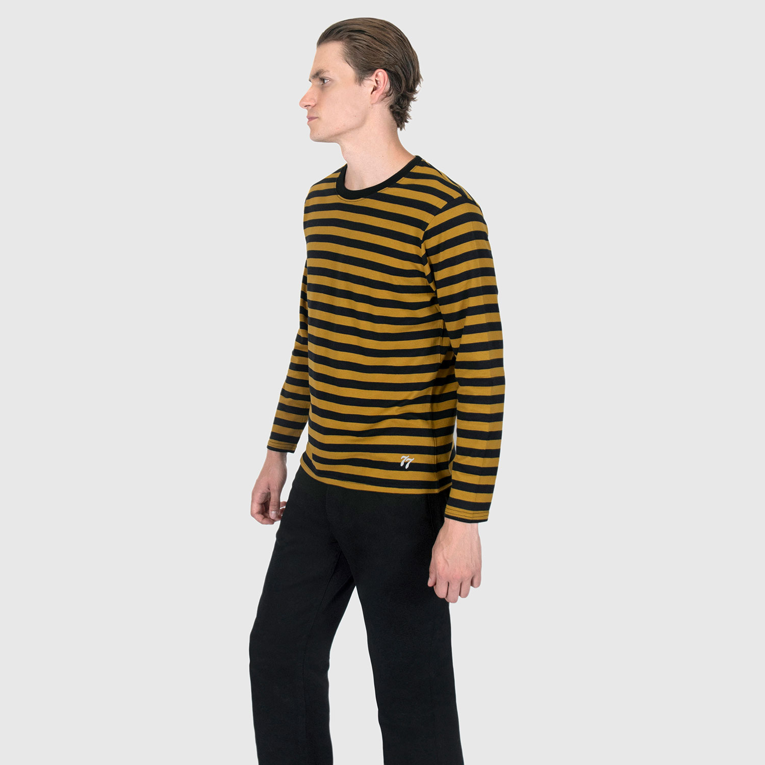 The Fitz 77 is a black and yellow striped, long sleeve t-shirt. This soft cotton-poly blend allows the fabric to drape comfortably on your torso. It features a subtle 77 embroidered on the lower corner. This is our Bucktown fit.