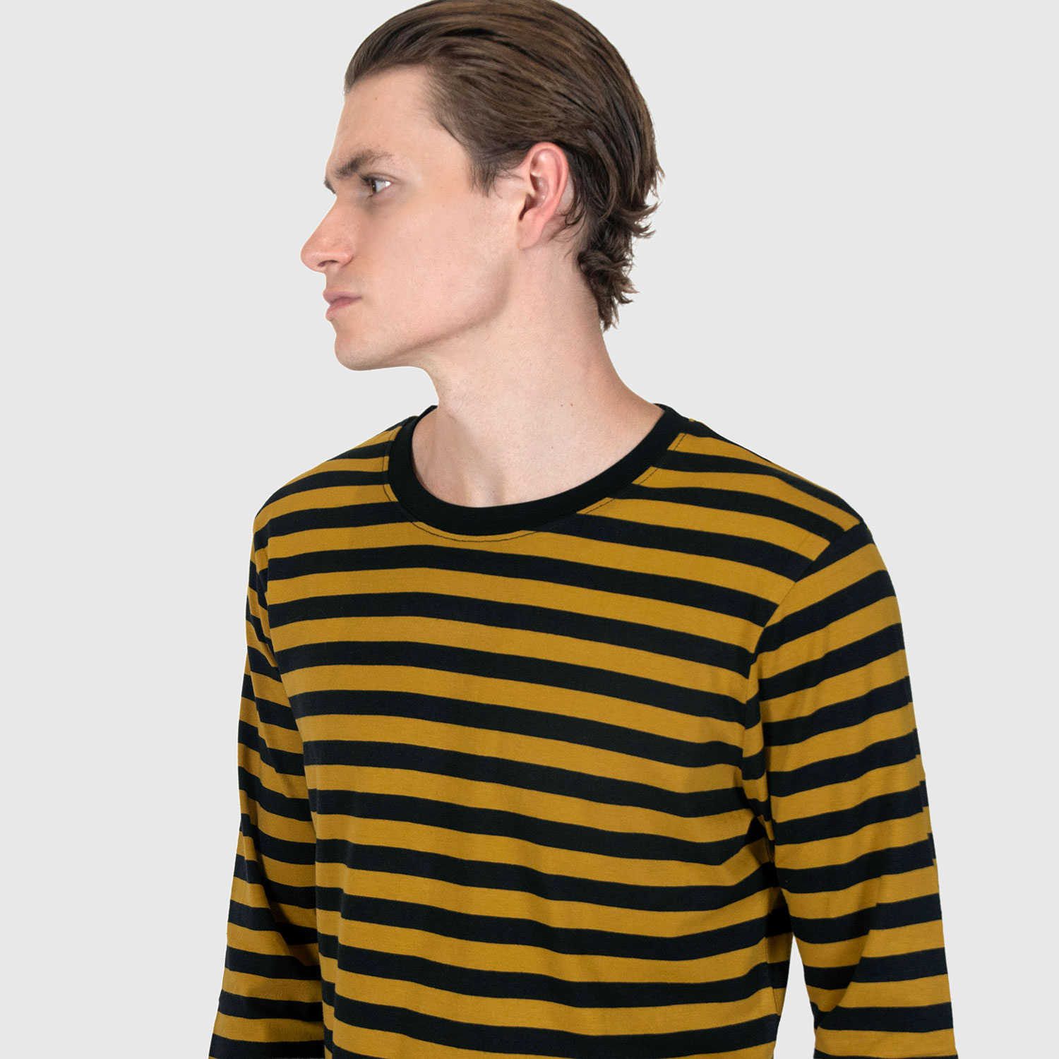 The Fitz 77 is a black and yellow striped, long sleeve t-shirt. This soft cotton-poly blend allows the fabric to drape comfortably on your torso. It features a subtle 77 embroidered on the lower corner. This is our Bucktown fit.