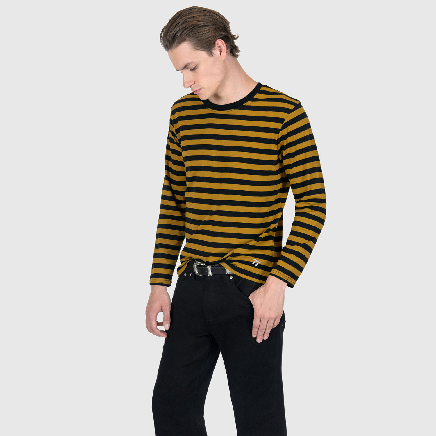 The Fitz 77 is a black and yellow striped, long sleeve t-shirt. This soft cotton-poly blend allows the fabric to drape comfortably on your torso. It features a subtle 77 embroidered on the lower corner. This is our Bucktown fit.