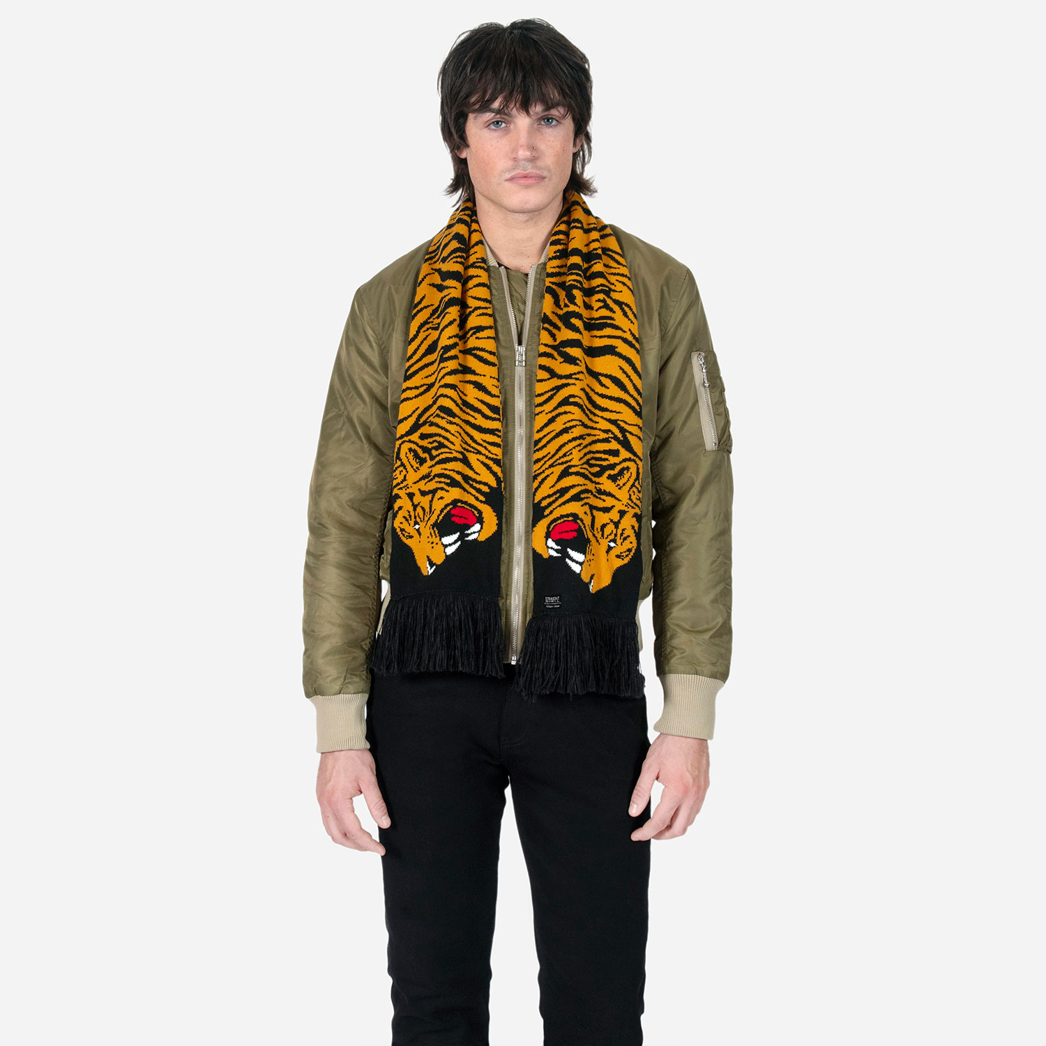 The Stray Tiger is a two-headed tiger soccer scarf with a discreet Straight To Hell statement. Some days a jacket isn't enough, and an ordinary scarf just won't do. Medium weight and measuring 57 inches. Made to be worn long in front or wrapped around the neck.