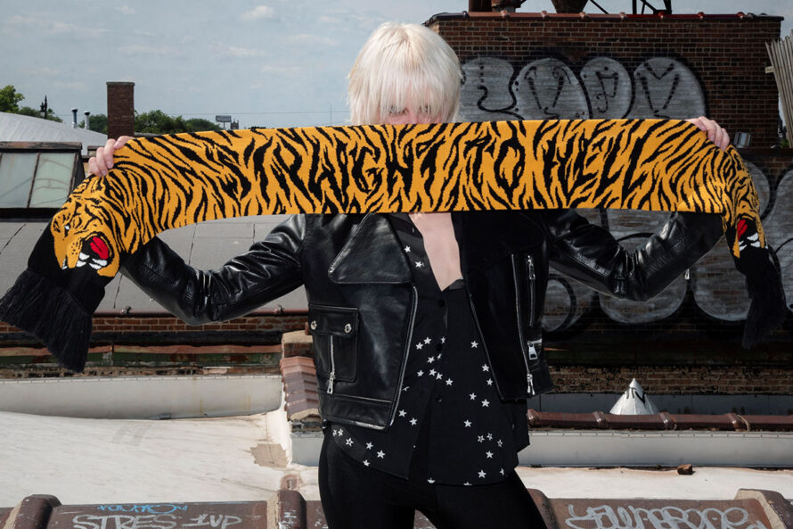 The Stray Tiger is a two-headed tiger soccer scarf with a discreet Straight To Hell statement. Some days a jacket isn't enough, and an ordinary scarf just won't do. Medium weight and measuring 57 inches. Made to be worn long in front or wrapped around the neck.