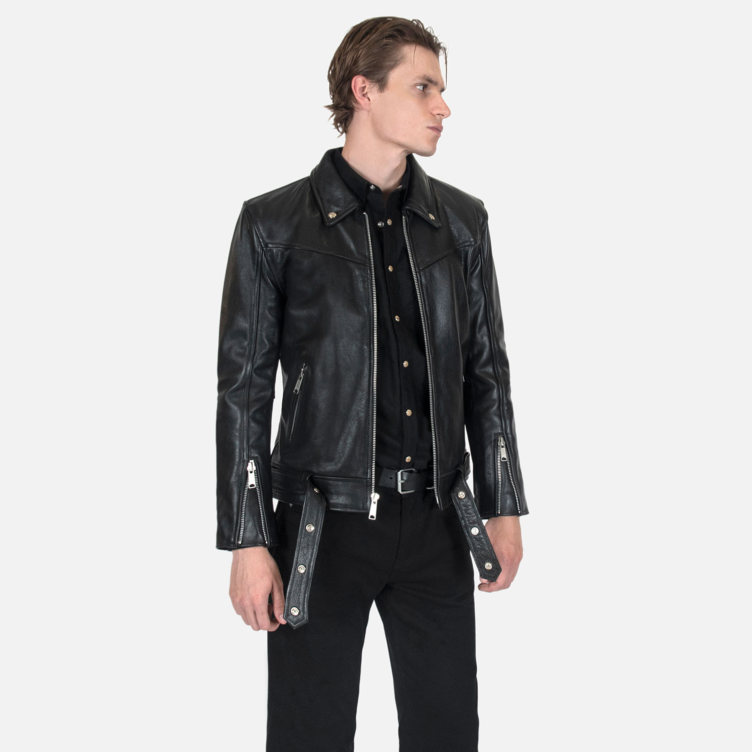 The Tribe leather jacket keeps things simple without sacrificing character. The diagonal chest seam detailing adds a subtle edge without complicating the design. A unique snap belt gives this classic style its own identity. Featuring a snap collar, vertical zipper closure, side pockets, and our Modern fit. All the attitude of a classic moto jacket, with a clean look that works just about anywhere. Made from premium leather that softens, relaxes, and conforms to your shape with wear, only getting better over time.