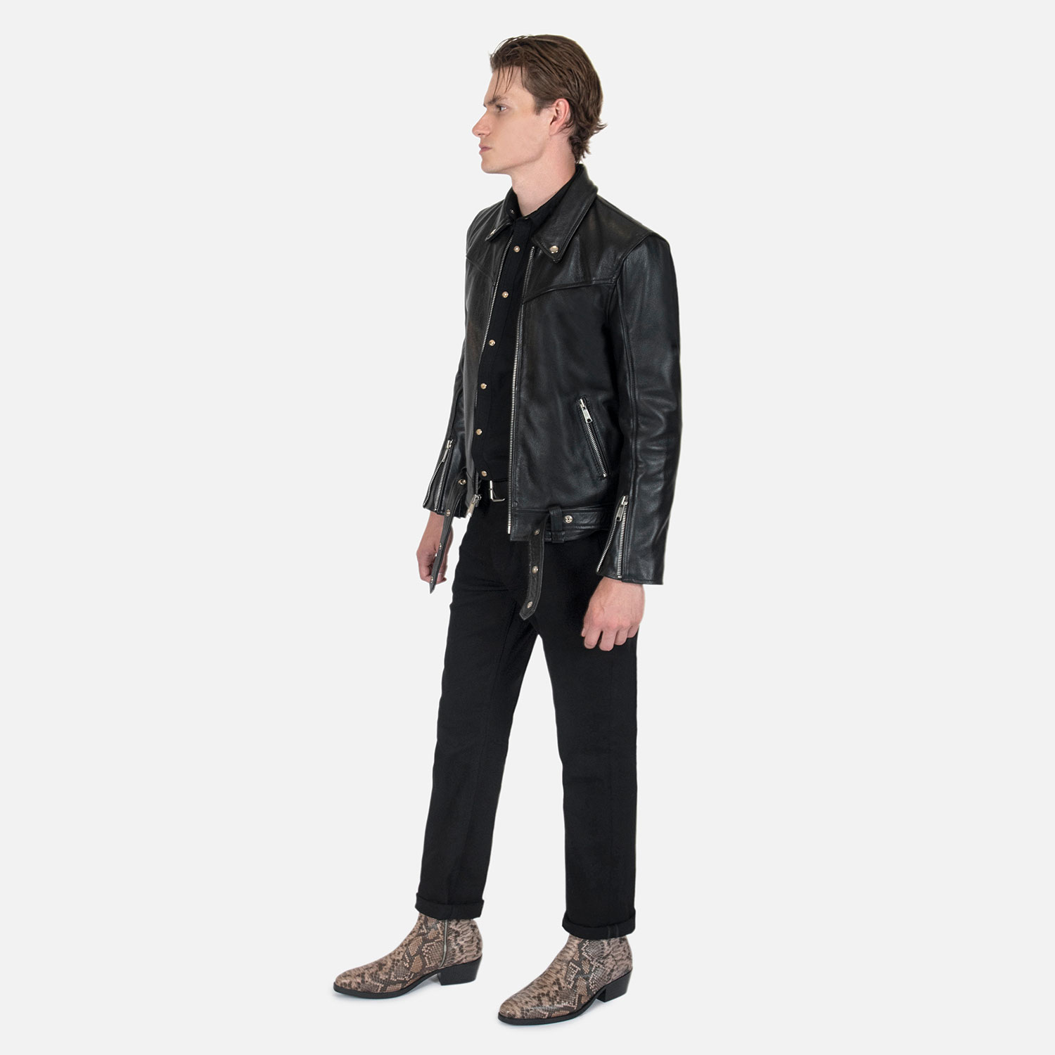 The Tribe leather jacket keeps things simple without sacrificing character. The diagonal chest seam detailing adds a subtle edge without complicating the design. A unique snap belt gives this classic style its own identity. Featuring a snap collar, vertical zipper closure, side pockets, and our Modern fit. All the attitude of a classic moto jacket, with a clean look that works just about anywhere. Made from premium leather that softens, relaxes, and conforms to your shape with wear, only getting better over time.