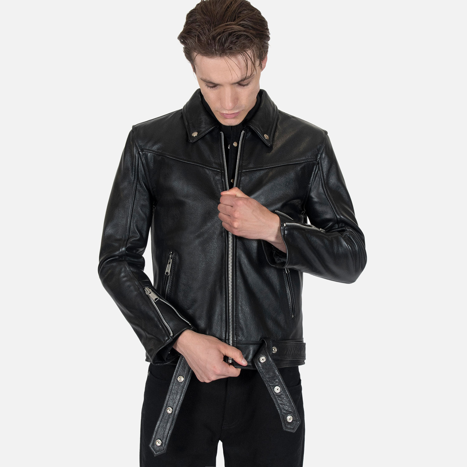 The Tribe leather jacket keeps things simple without sacrificing character. The diagonal chest seam detailing adds a subtle edge without complicating the design. A unique snap belt gives this classic style its own identity. Featuring a snap collar, vertical zipper closure, side pockets, and our Modern fit. All the attitude of a classic moto jacket, with a clean look that works just about anywhere. Made from premium leather that softens, relaxes, and conforms to your shape with wear, only getting better over time.
